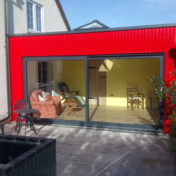 Contemporary red rear house extension in Hampton-on-the-Hill