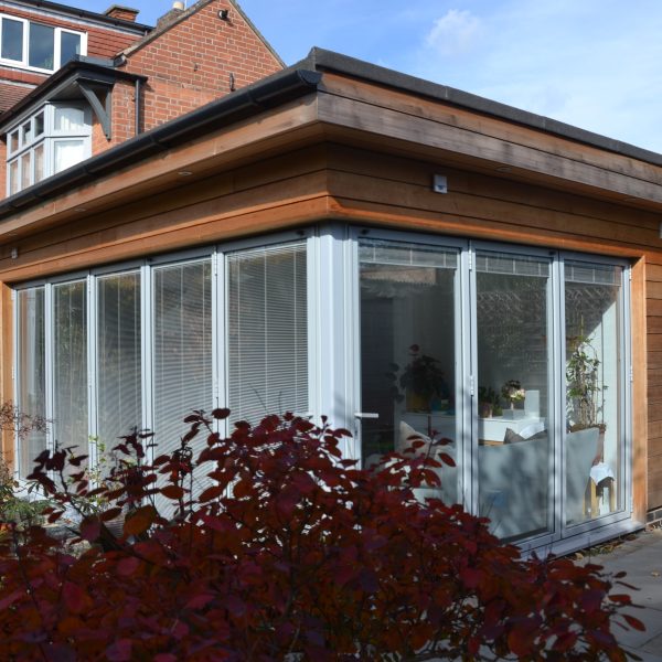 Timber-clad house extension with full-height glazing in Leicester